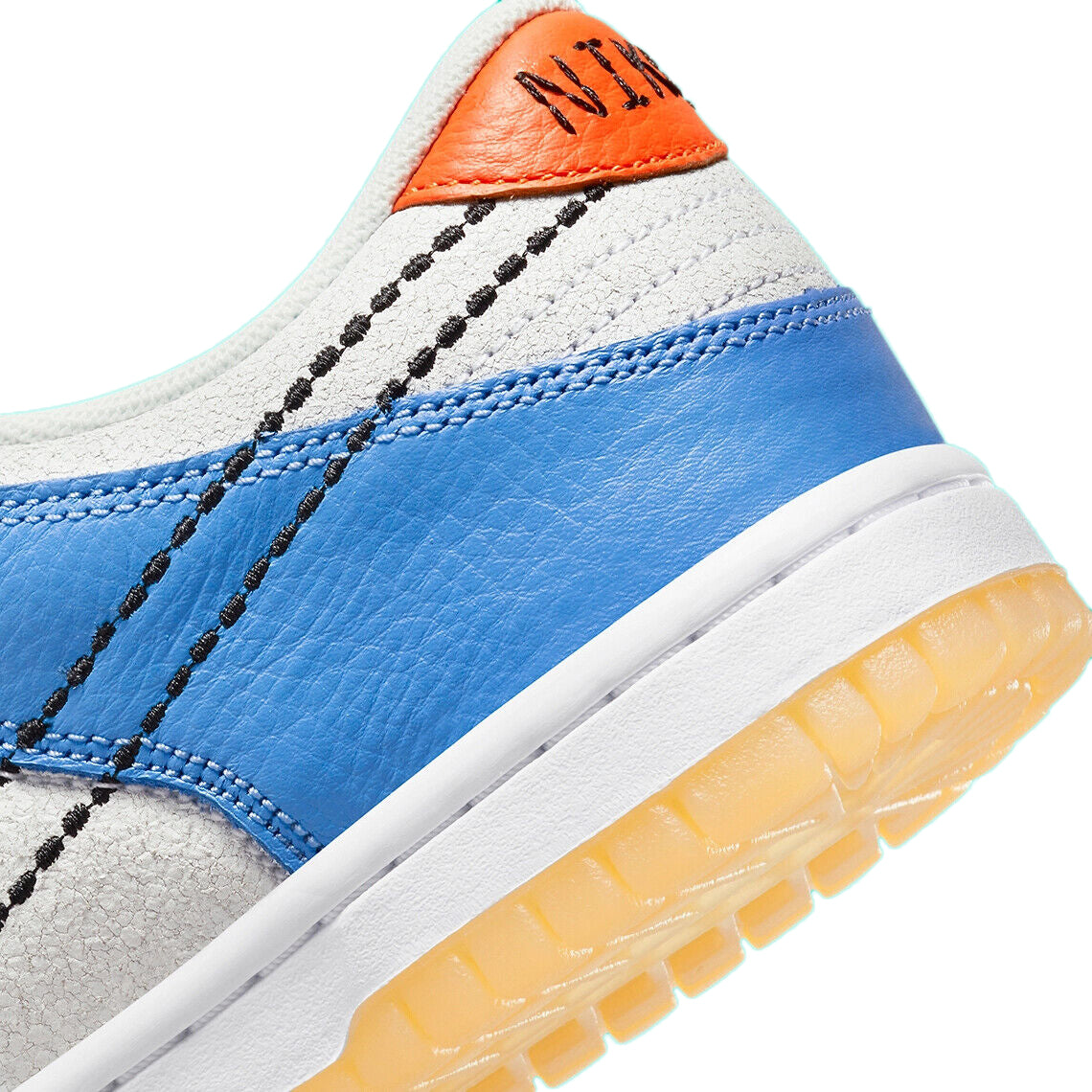 Kids sneaker quarter panel close-up with blue leather, orange collar, and stitched black Swoosh