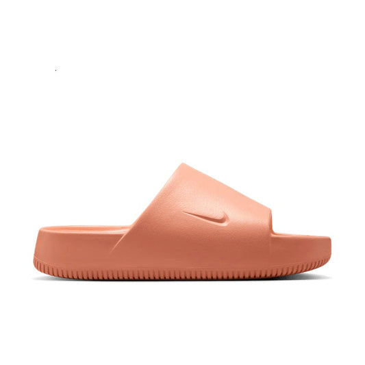 Nike women's slide sandals in apricot with molded footbed and slip-on design