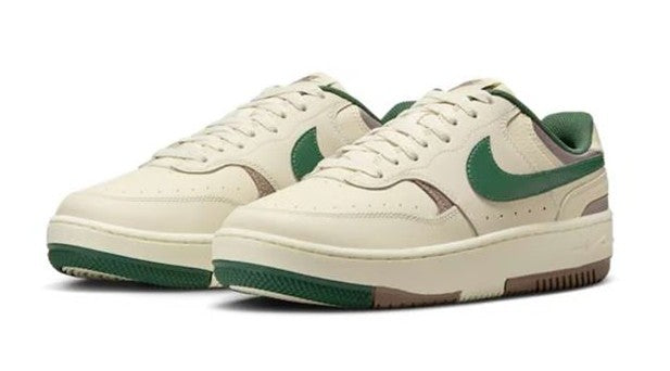 Pair of women's Nike low-top sneakers in cream with green accents and brown midsoles