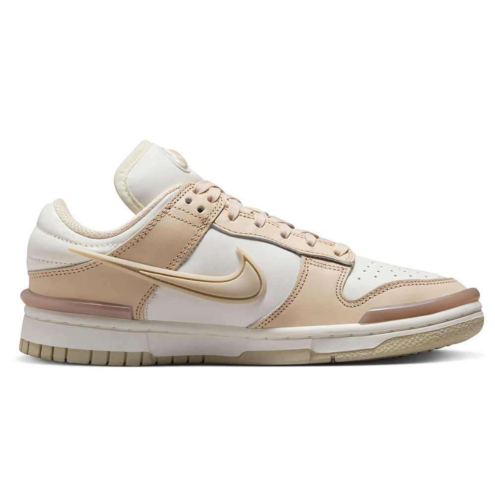Low-top sneaker side view with sail base, sand overlays, gold Swoosh, and lace-up