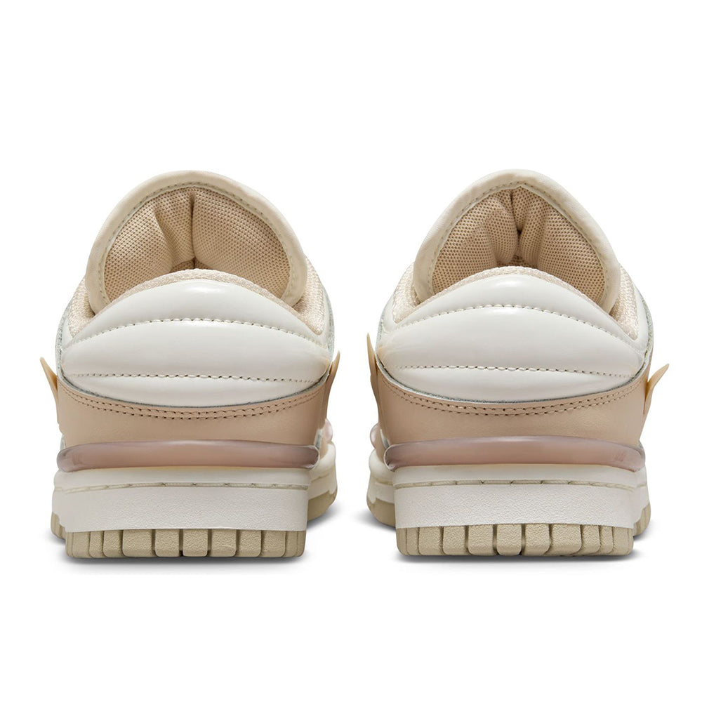 Back view of low-top sneakers with cushioned heel, sail panels, and sand trim