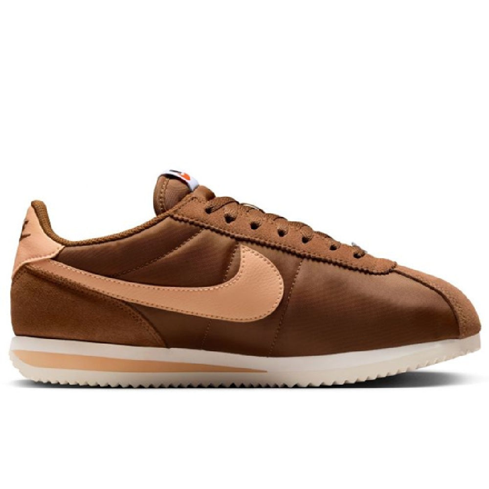 Women's Nike Cortez LT lace-up sneakers in brown with cream overlays and orange detail.