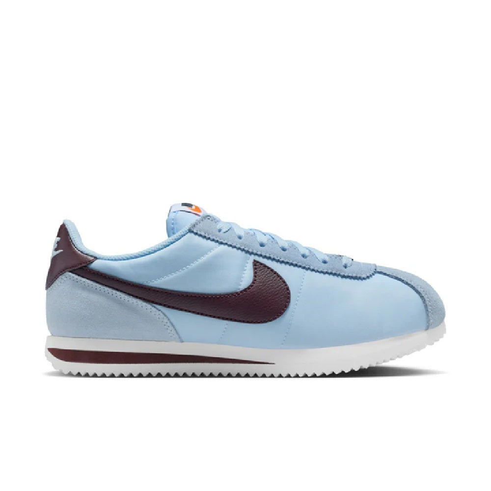 Nike Cortez low-top sneakers in light blue with burgundy Swoosh and lace-up design