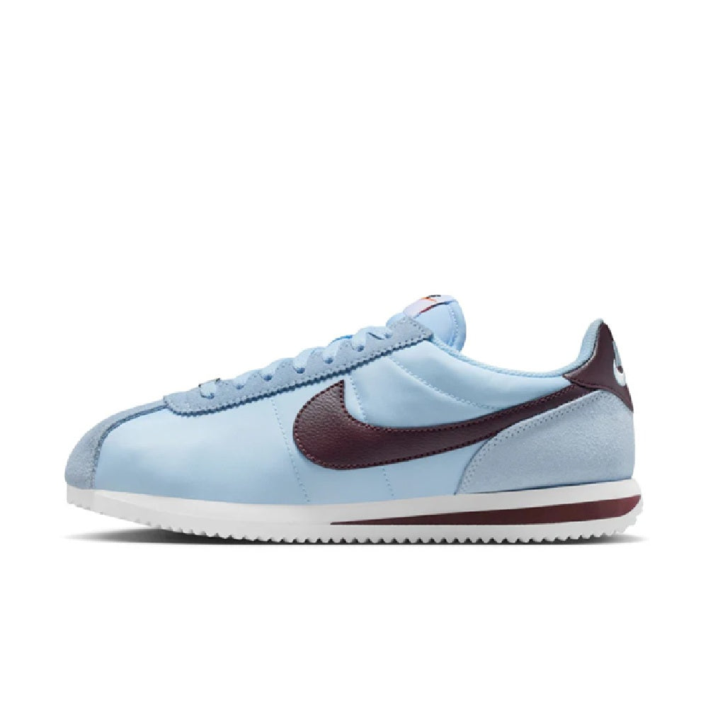 Nike Cortez low-top sneakers, light blue leather with burgundy Swoosh and flat sole