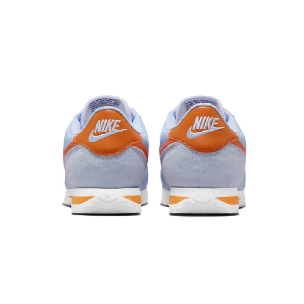Nike Cortez sneakers, heel back view with Nike logo, light blue and orange accents