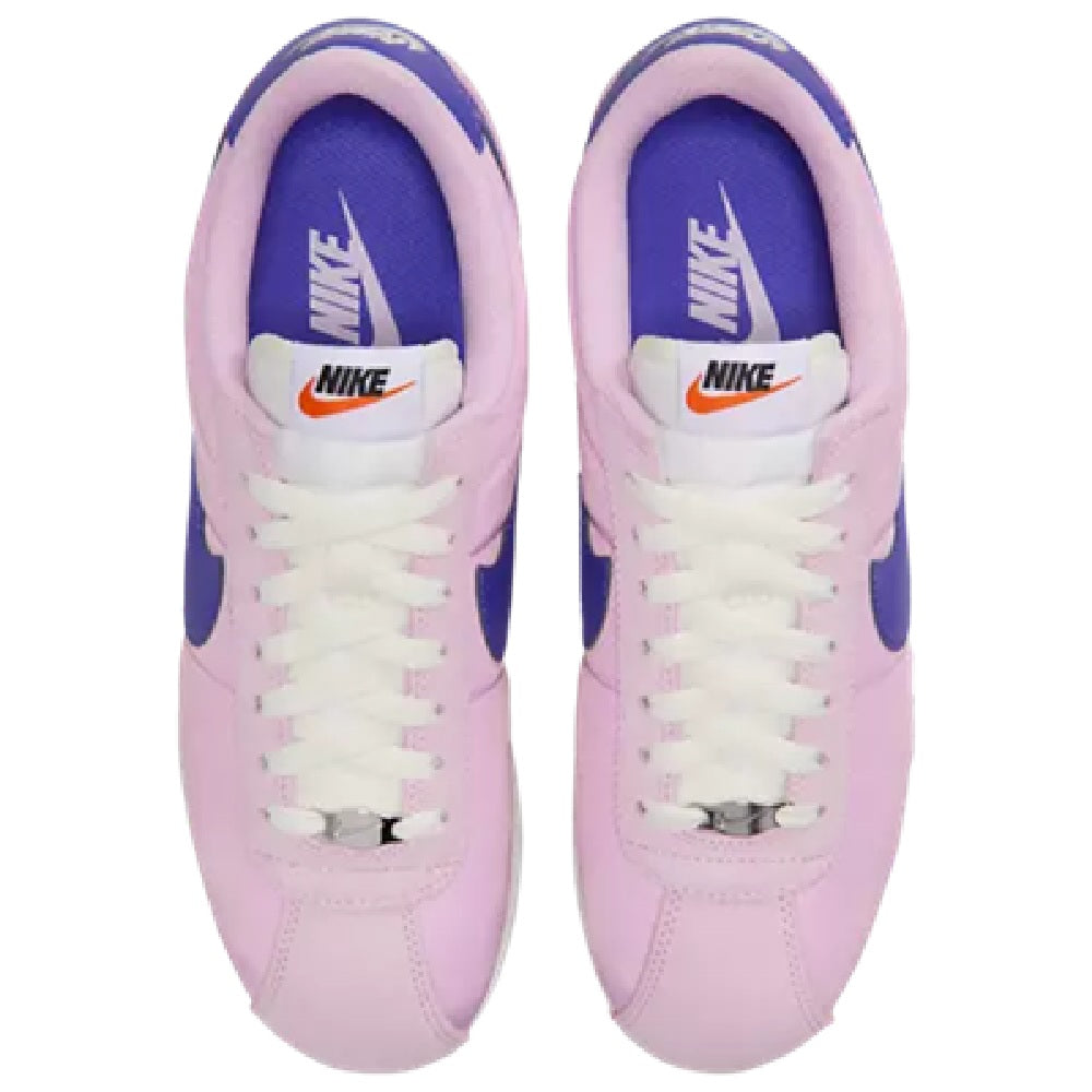 Women's Nike Cortez LT toe view, pink uppers with white laces and blue collar lining.