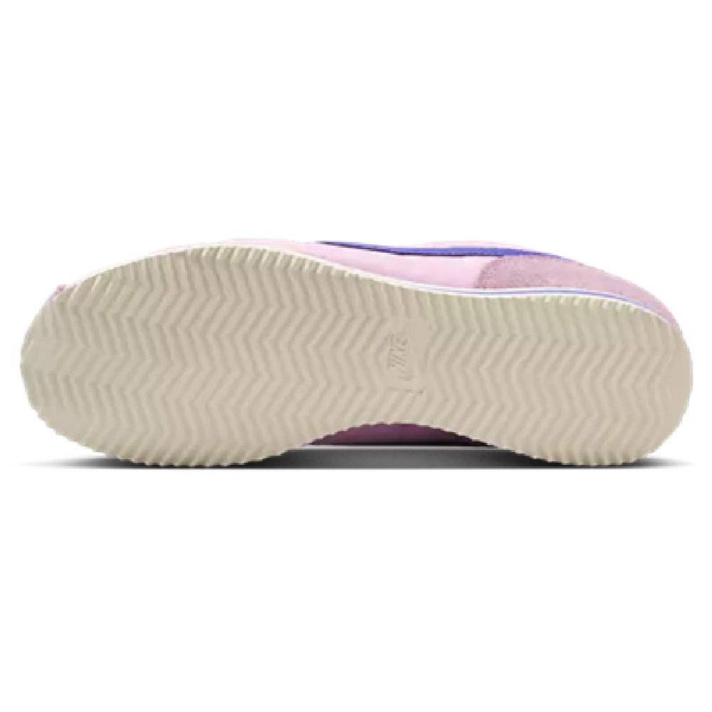 Nike Cortez LT gum outsole with textured tread on pink sneaker bottom.
