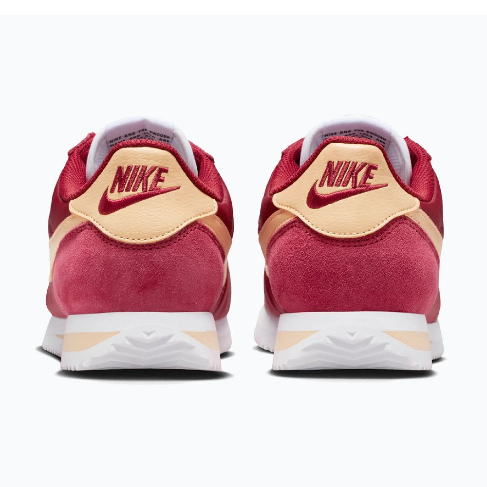 Back view of women's red Cortez sneakers with Nike logo and cream heel tab