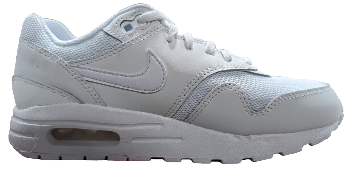 Kids' Nike Air Max 1 sneakers in white, side profile with swoosh and cushioned midsole