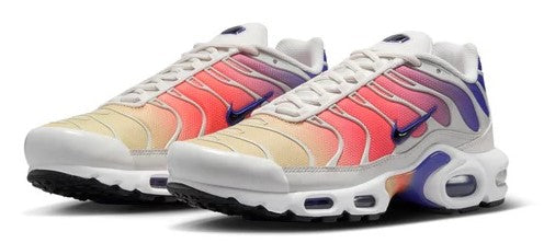 Nike Air Max Plus sneakers pair, off-white base with pink panels, blue details, lace-up.
