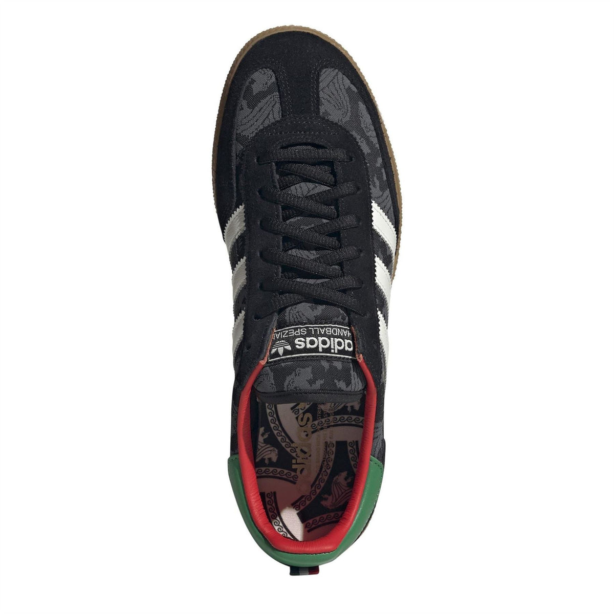 Black low-top lace-up trainer with red and green inner lining detail