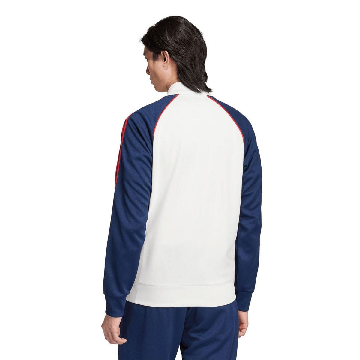Back view of white zip track jacket with navy sleeves and red stripe detail