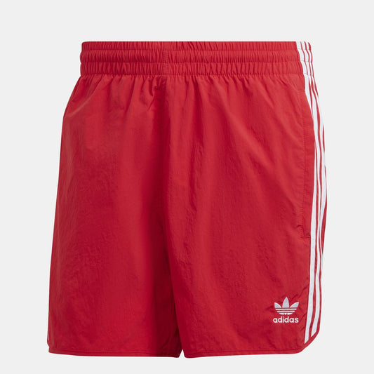 Red sprinter shorts with elastic waist, white side stripes, and adidas logo