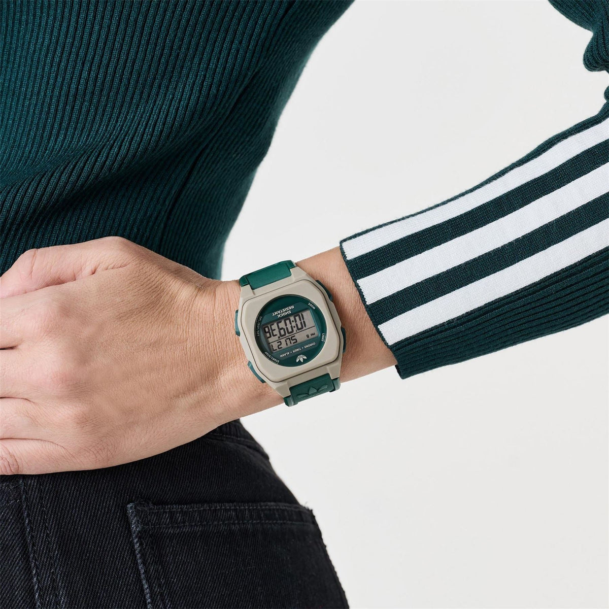 adidas Originals digital watch on wrist with green strap and beige bezel