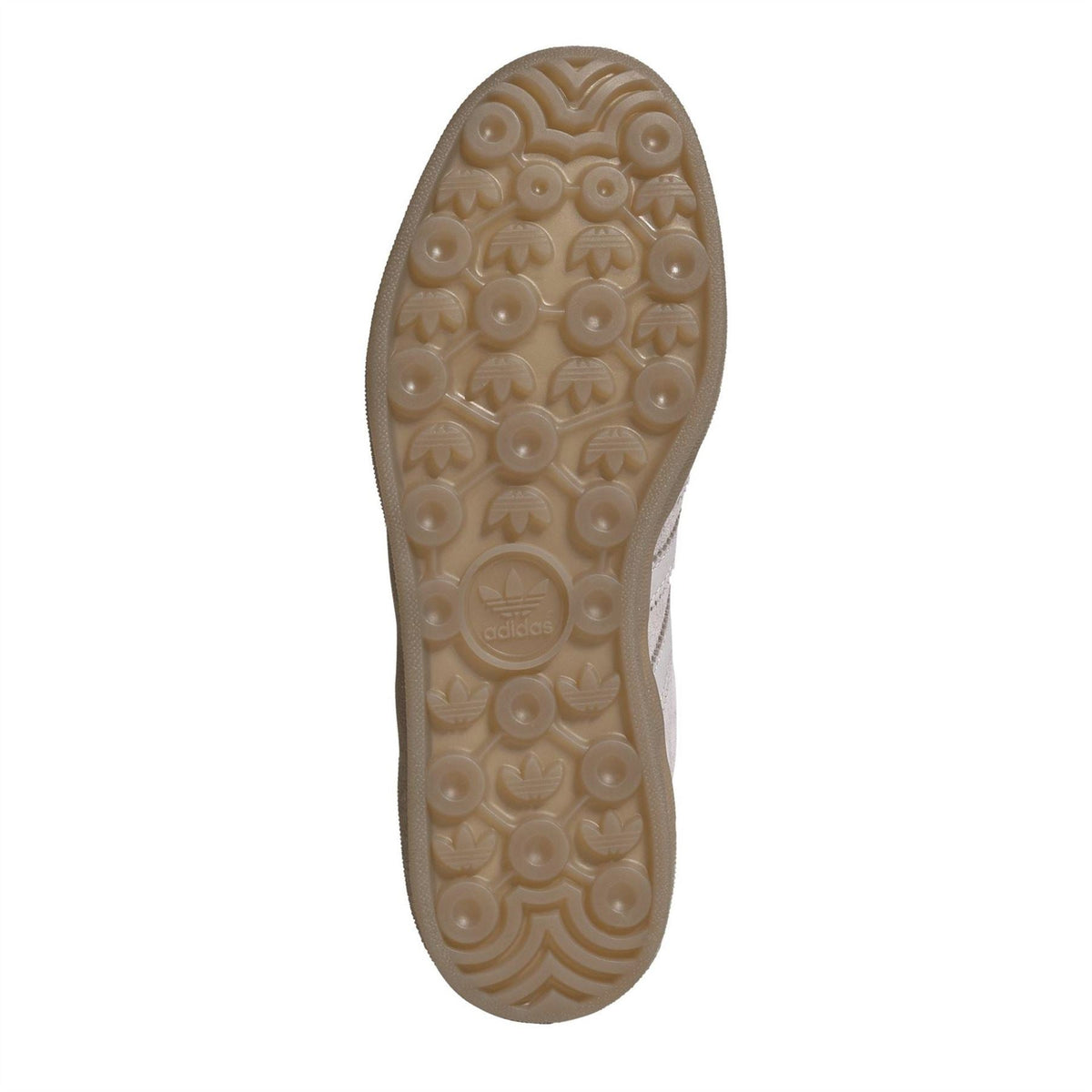 Outsole of light suede lace-up trainers with textured gum rubber pattern.