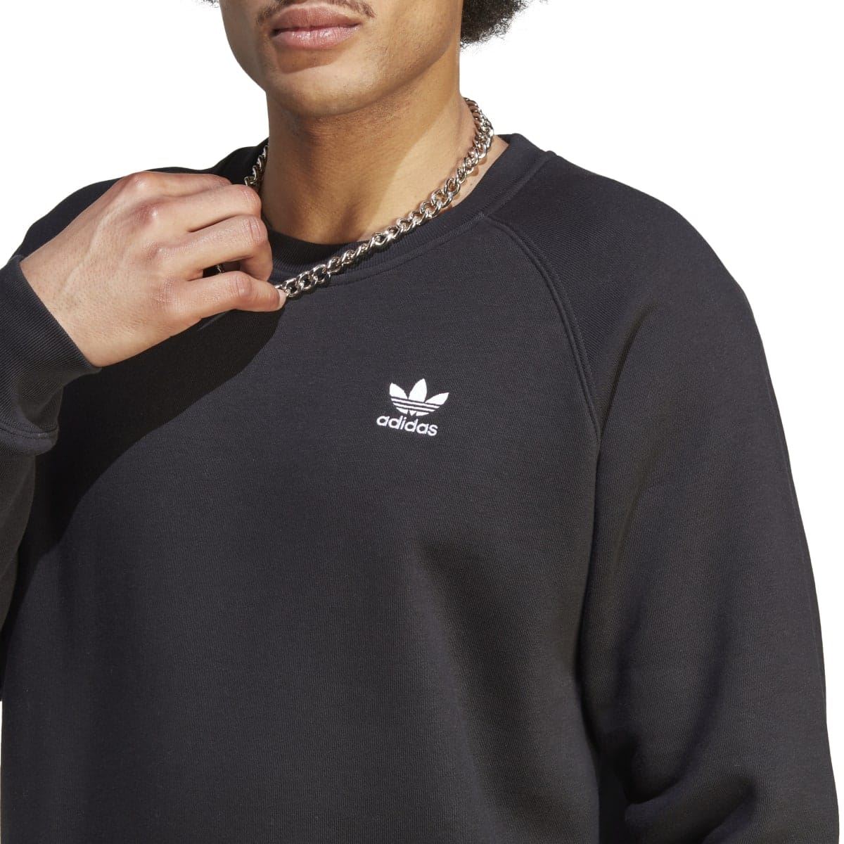 adidas Originals Trefoil Essentials crewneck sweatshirt in gray, showing the classic logo and comfortable fit on a model