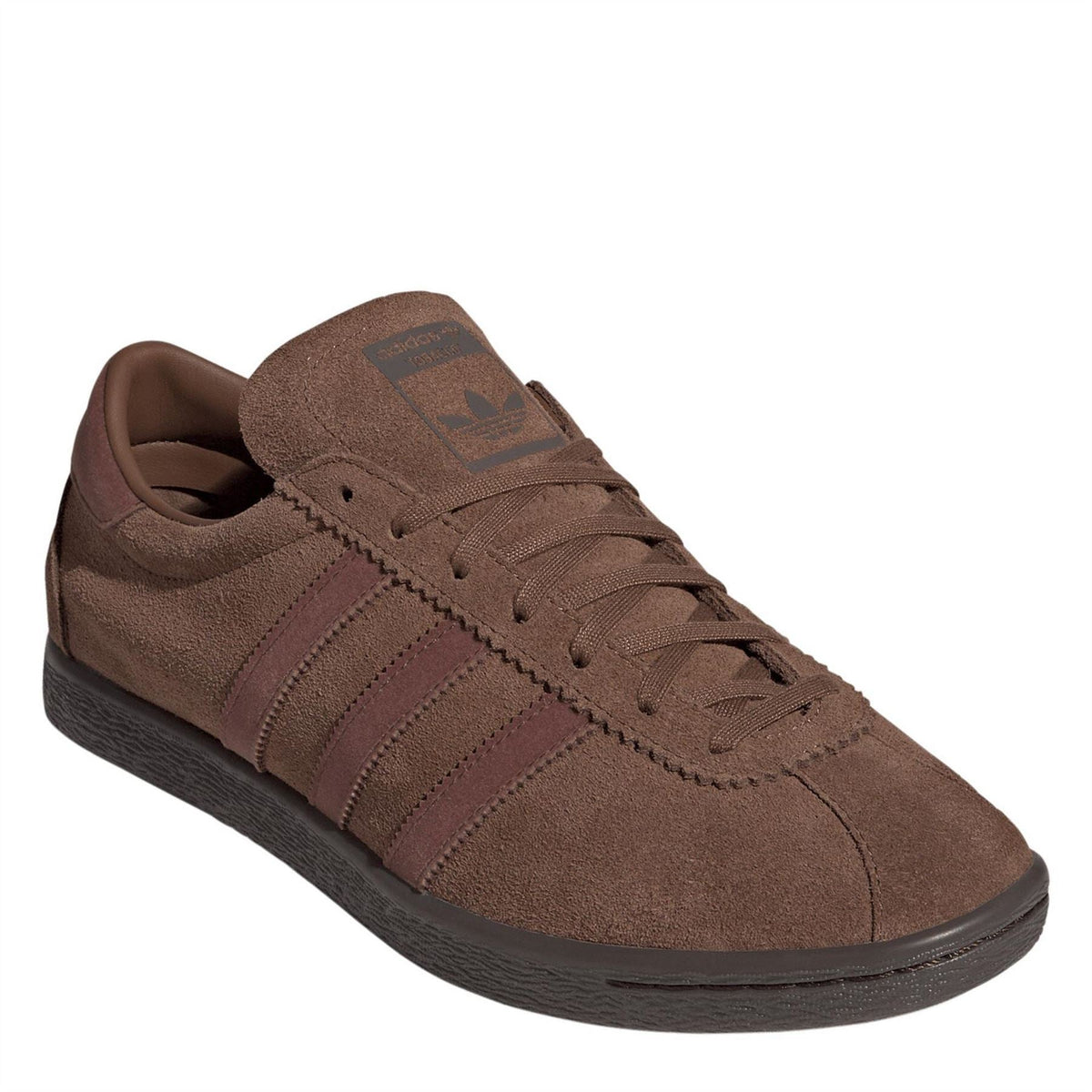 Brown adidas Originals trainer with suede upper, lace-up, and patterned tongue label