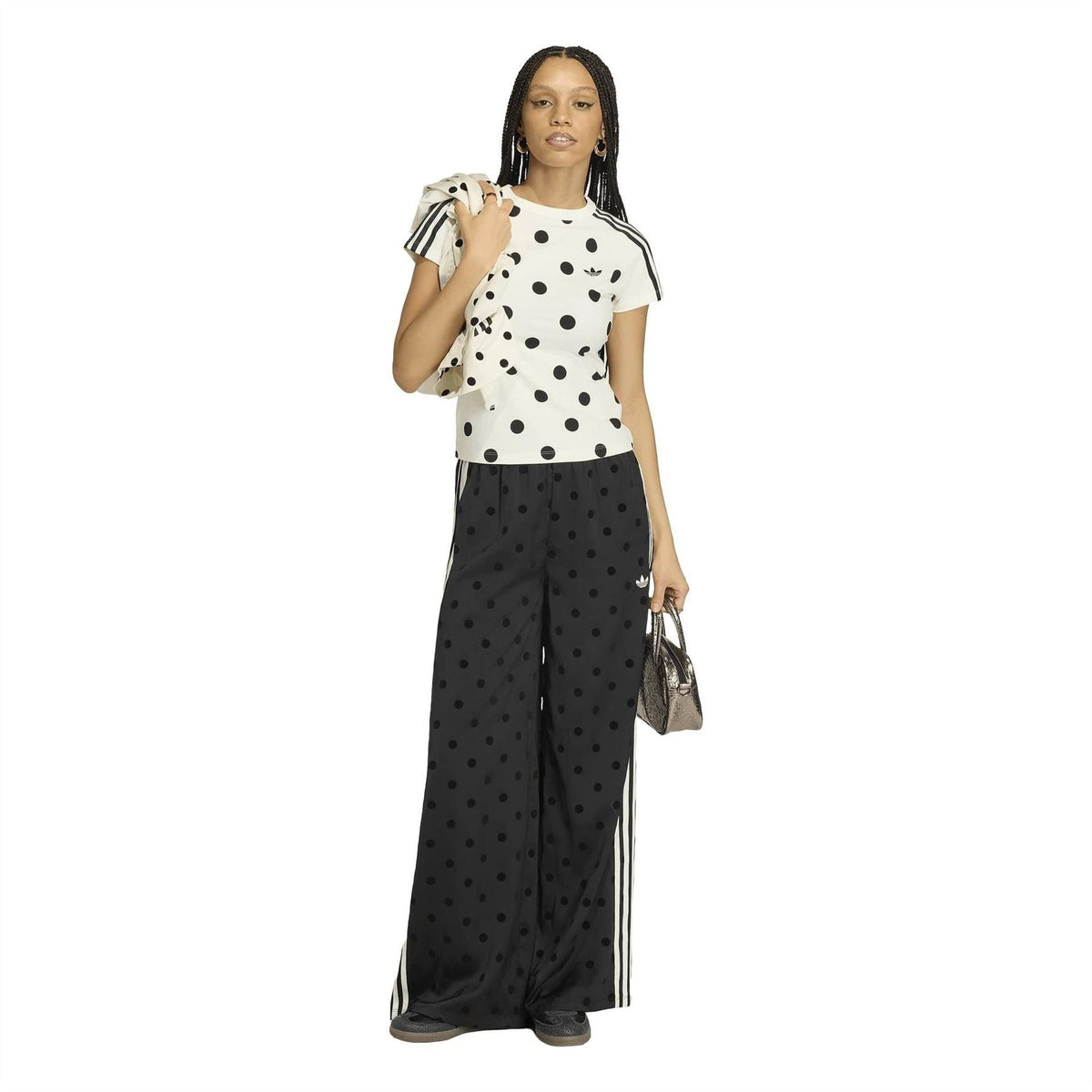 Black polka-dot wide-leg pants with elastic waist and vertical white side stripes