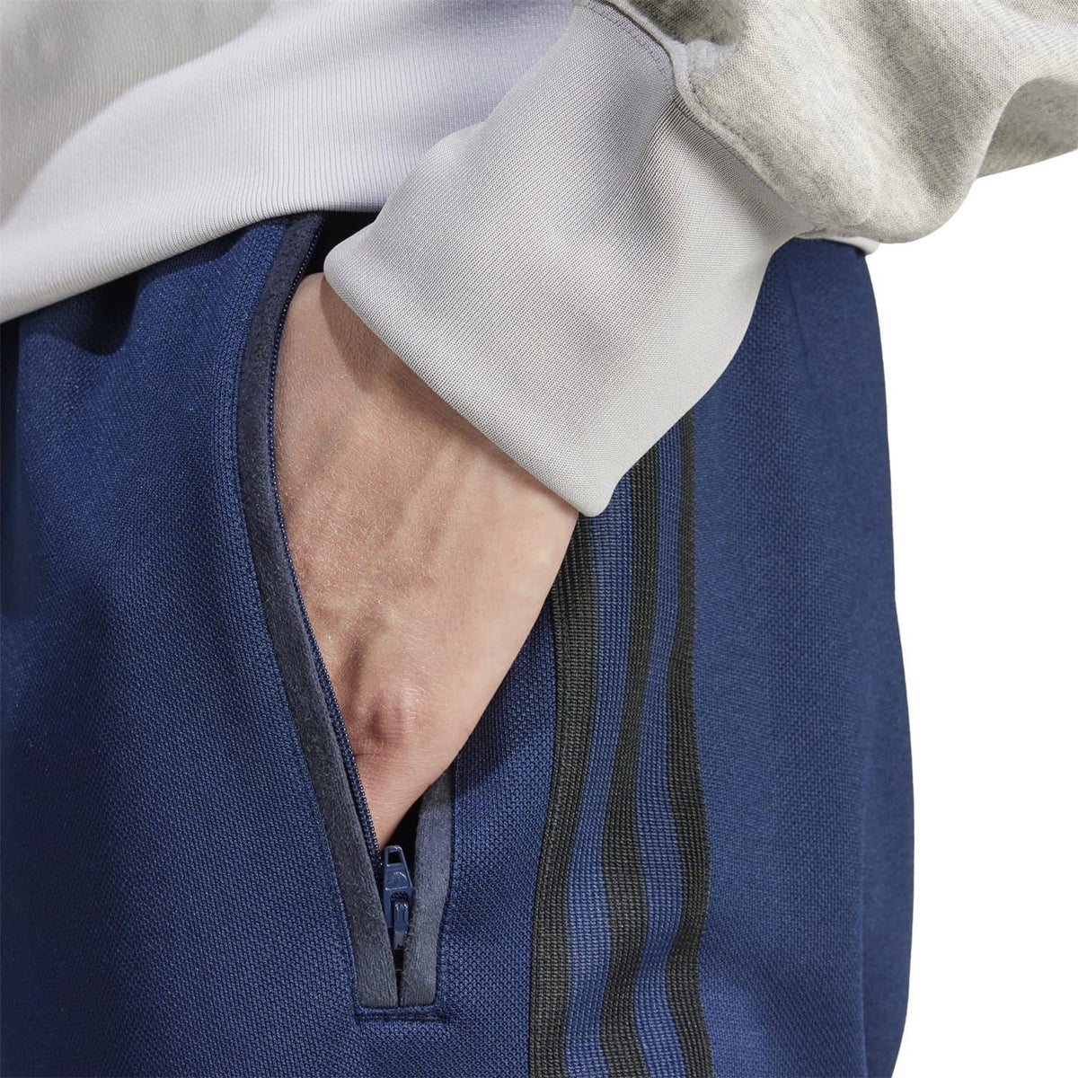 Navy blue joggers with side zipper pocket and vertical stripe detailing
