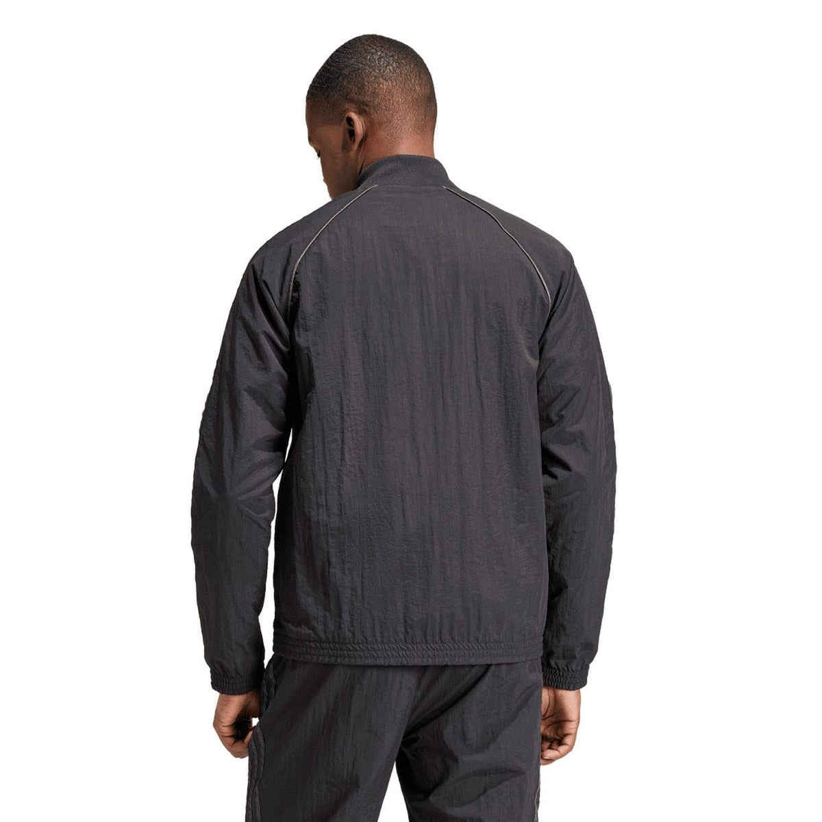 Black track jacket back view with full-length zip, ribbed cuffs and hem.