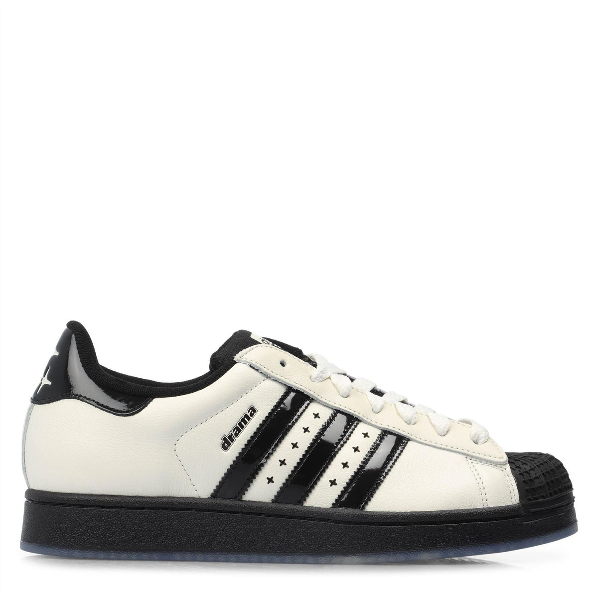 Off-white low-top adidas Originals trainers with black stripes and lace-up front