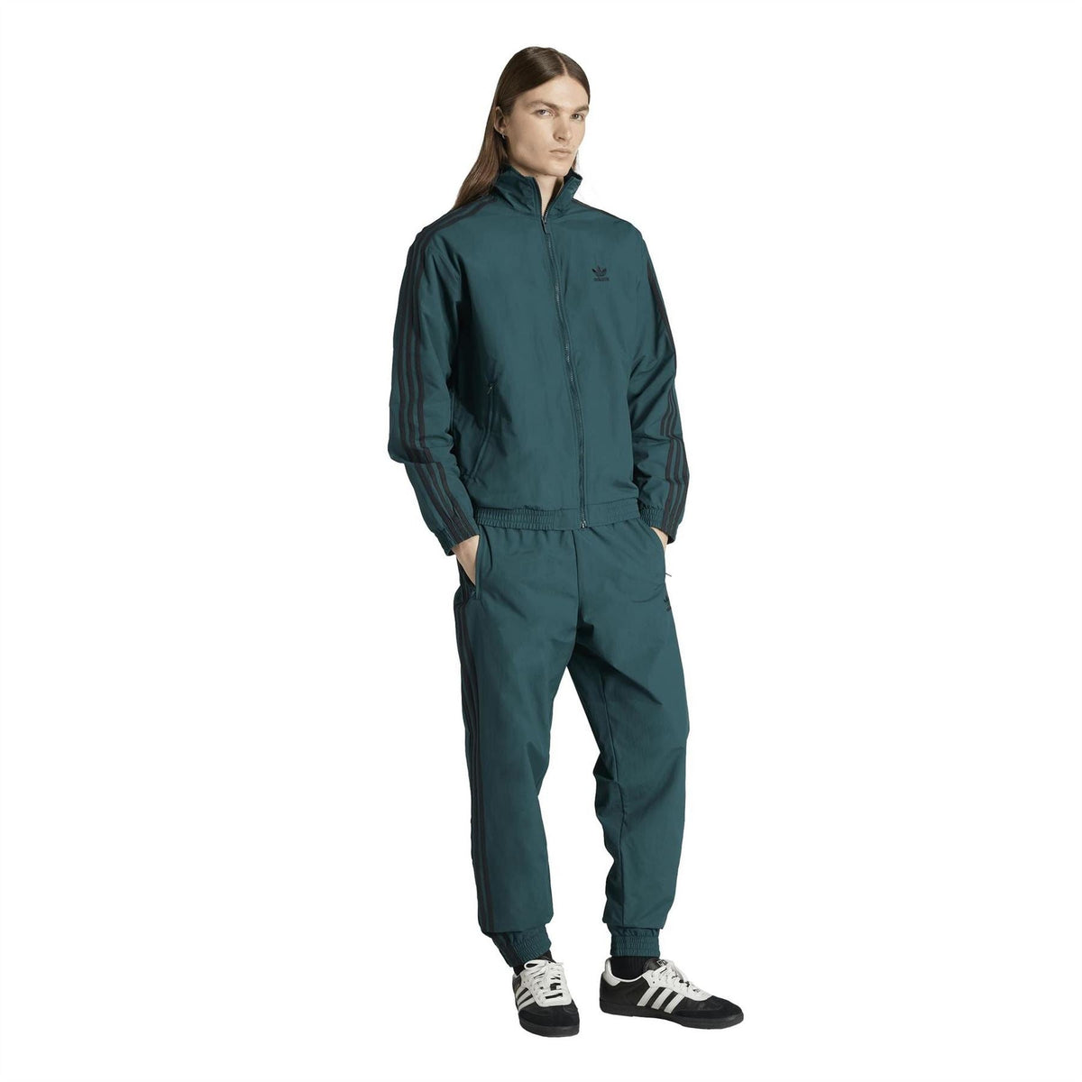 Women’s adidas teal track top worn with matching track pants, full body view