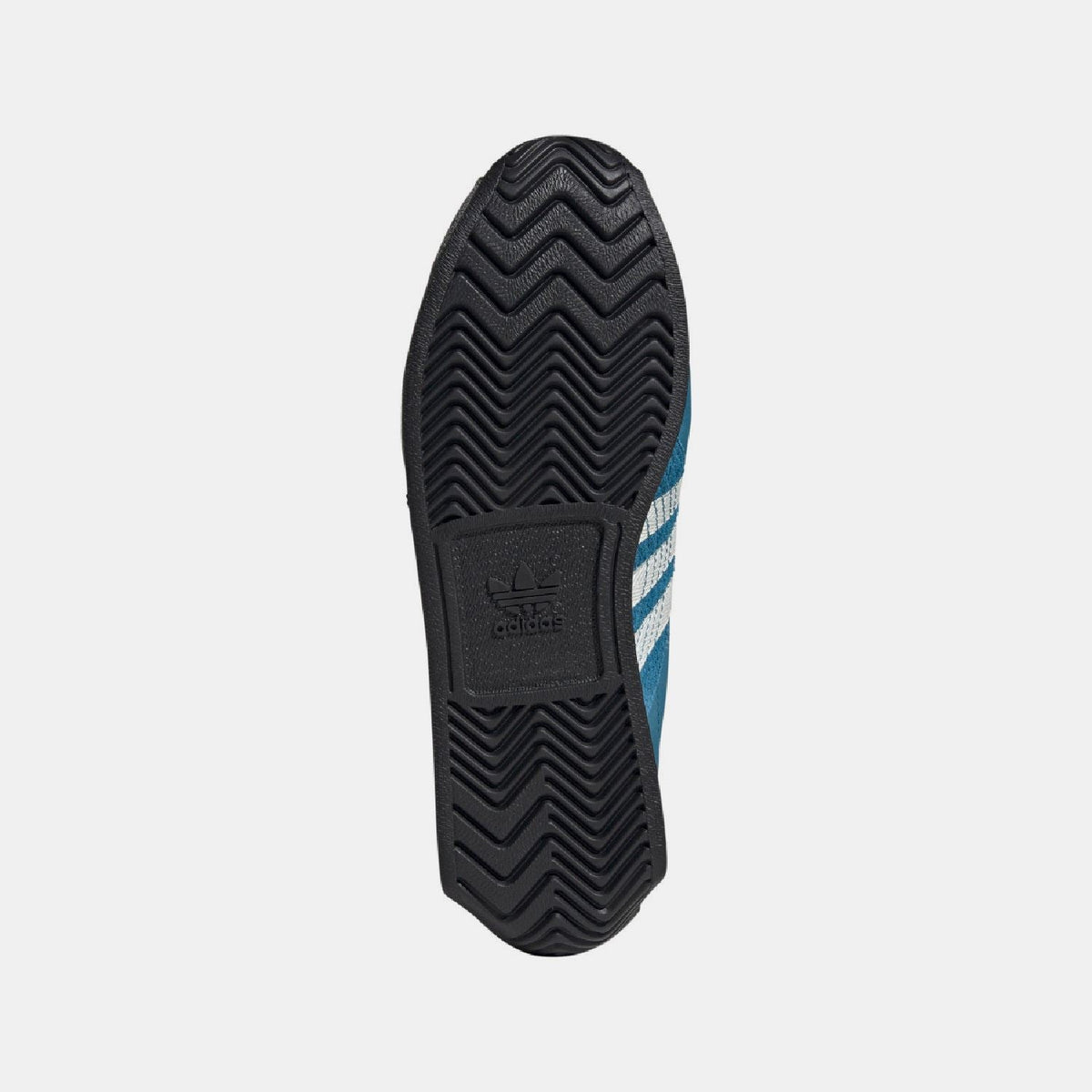 Bottom view of teal trainers showing textured black outsole and adidas logo on heel
