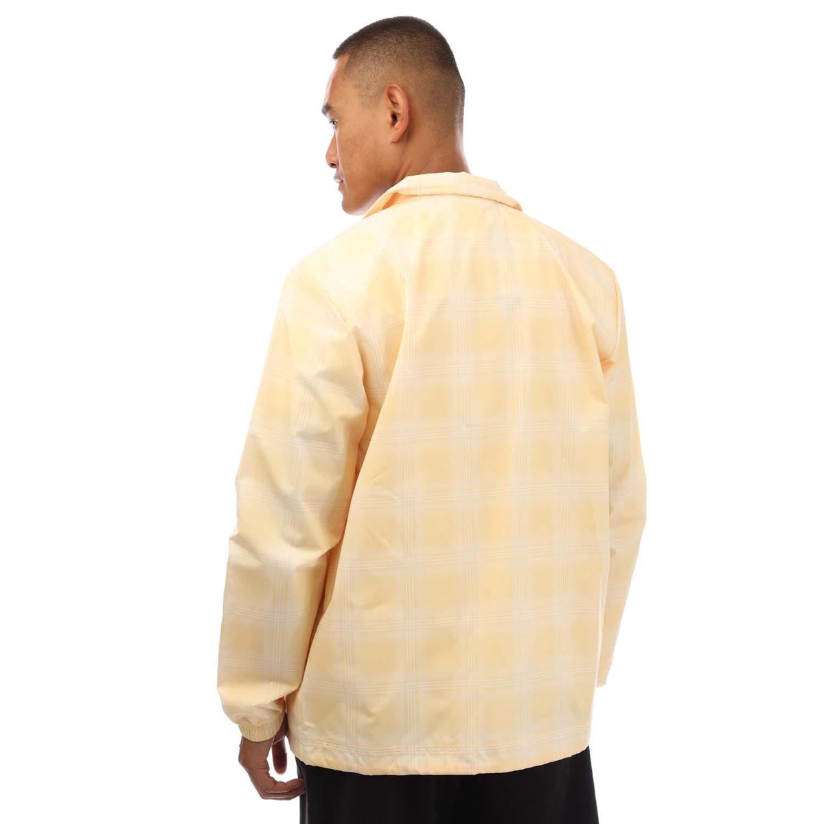 light yellow coach jacket back view with button-up yoke and elastic hem drawcord