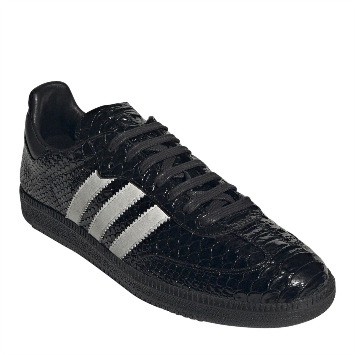 Black low-top sneakers with white triple stripes and lace-up front, glossy toe
