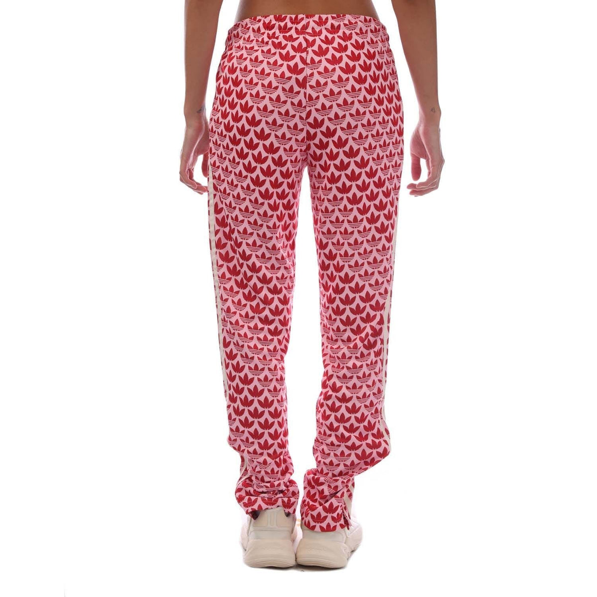 Pink track pants with repeating heart pattern, straight legs, elastic cuffs