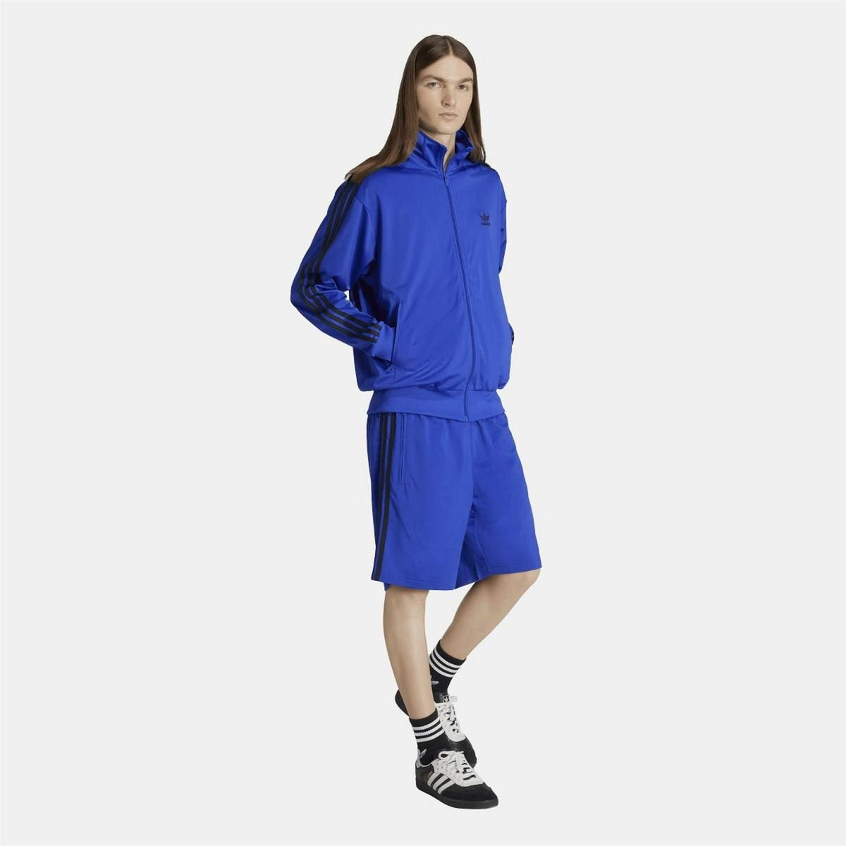 adidas Originals Firebird Track Top in navy with white stripes, showcasing the classic sporty design and logo on the chest.