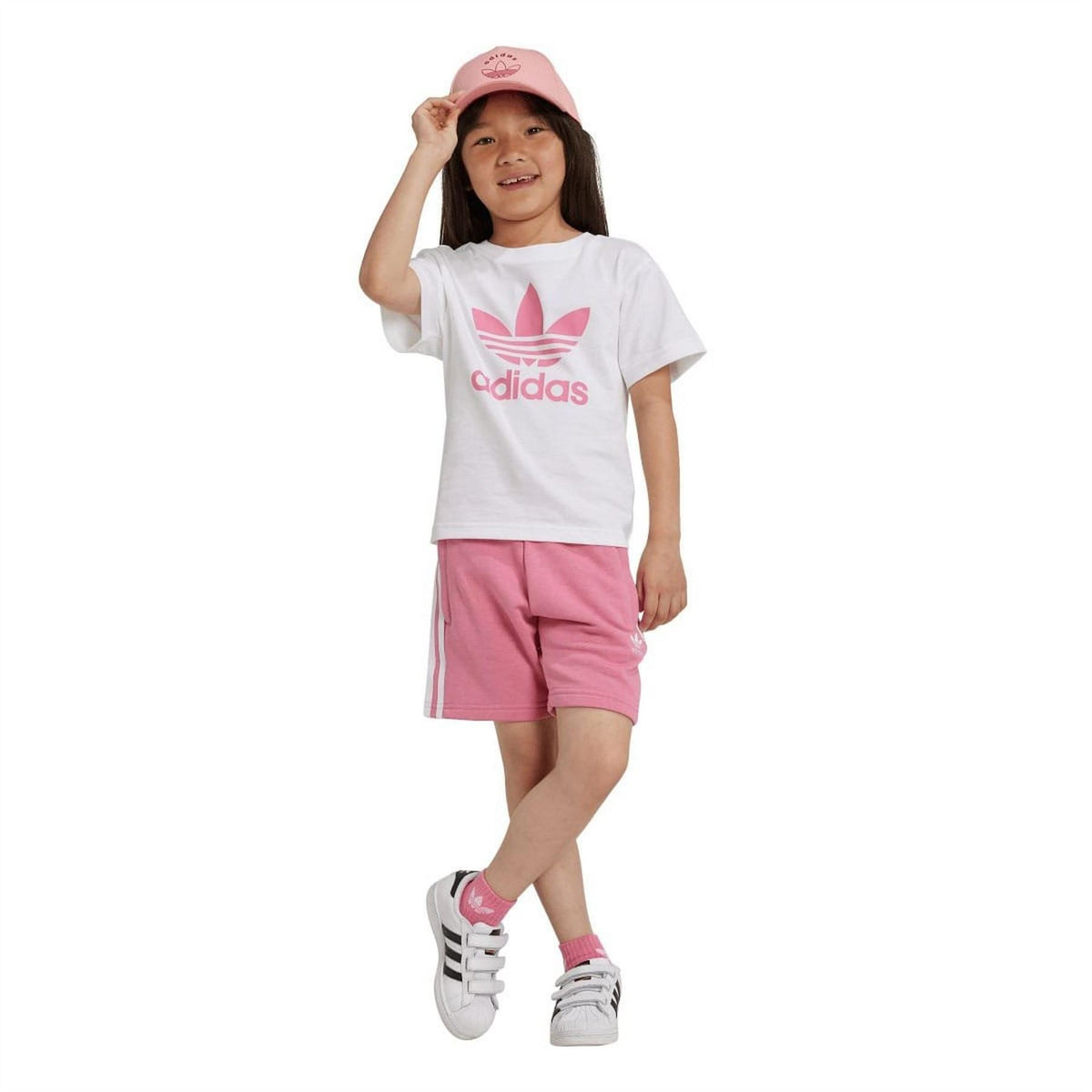 Kids adidas rose shorts and white T-shirt set with trefoil logo, wearing pink cap