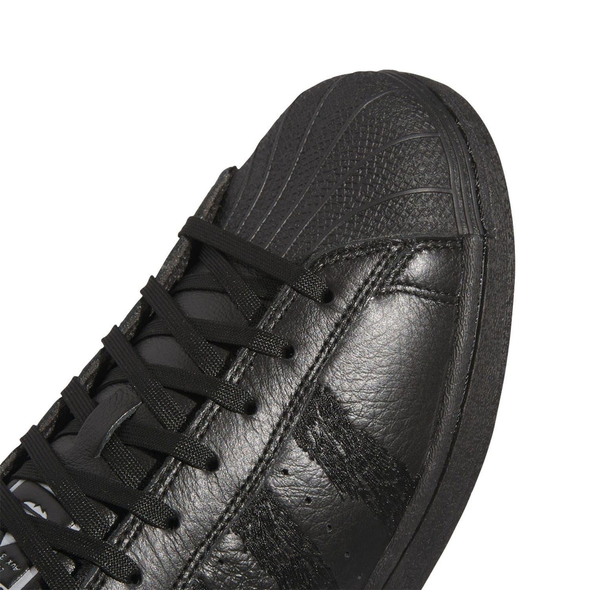 Black leather-like upper close-up with laces and textured paneling