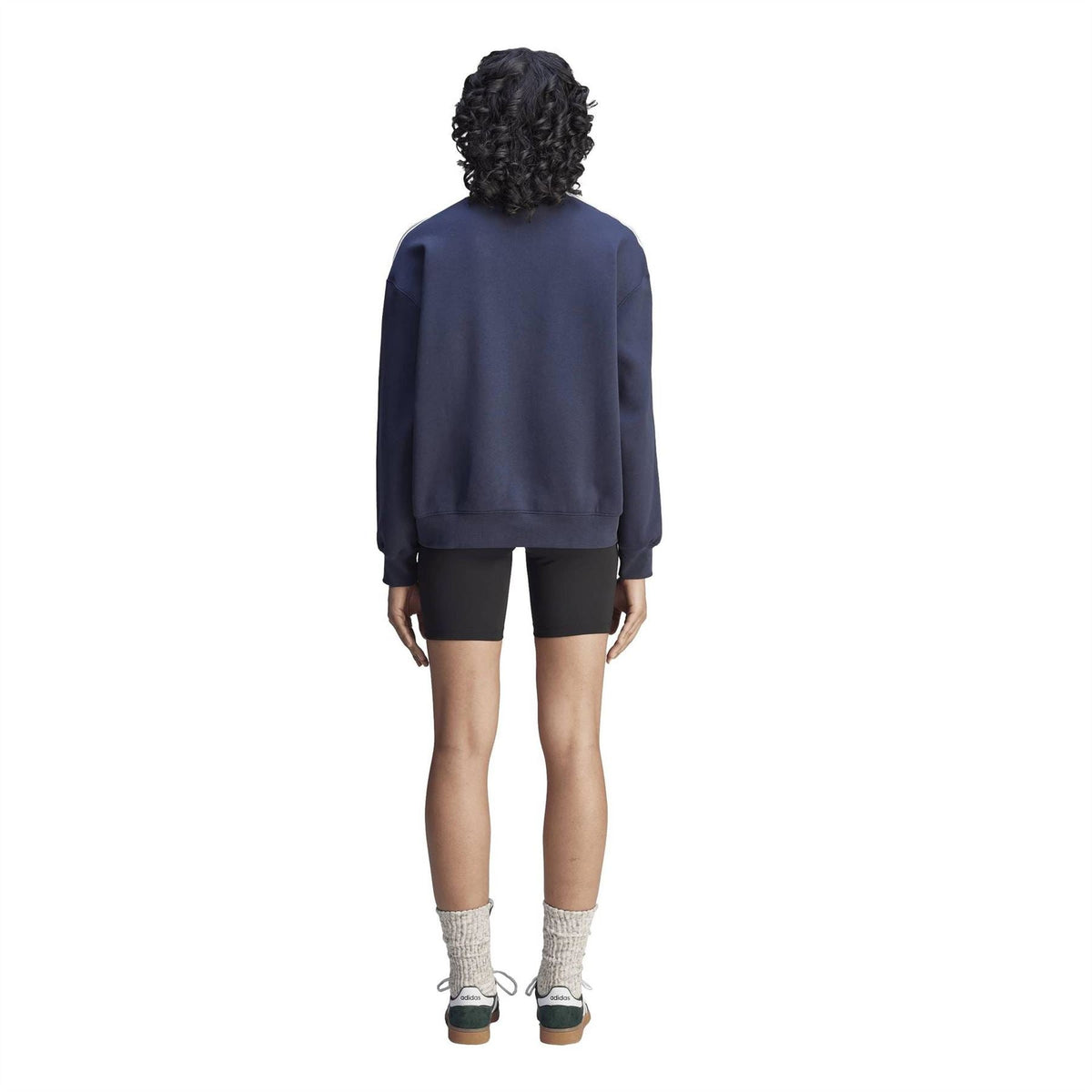 Navy sweatshirt back view with ribbed cuffs, worn over black biker shorts