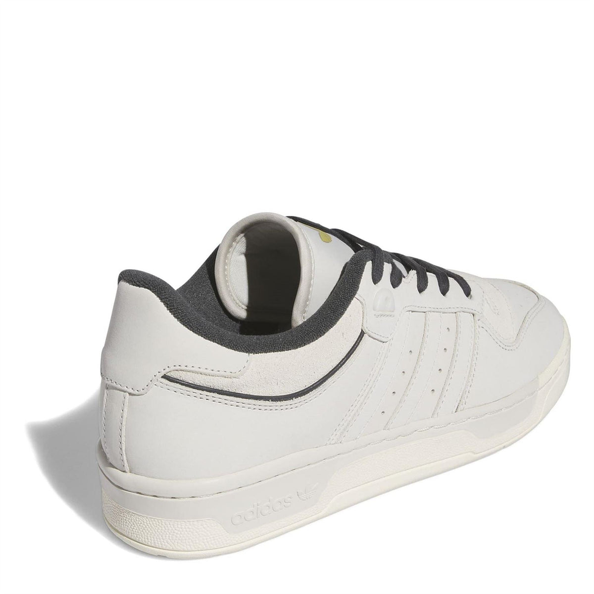 White low-top sneakers with black heel lining and rear collar detail