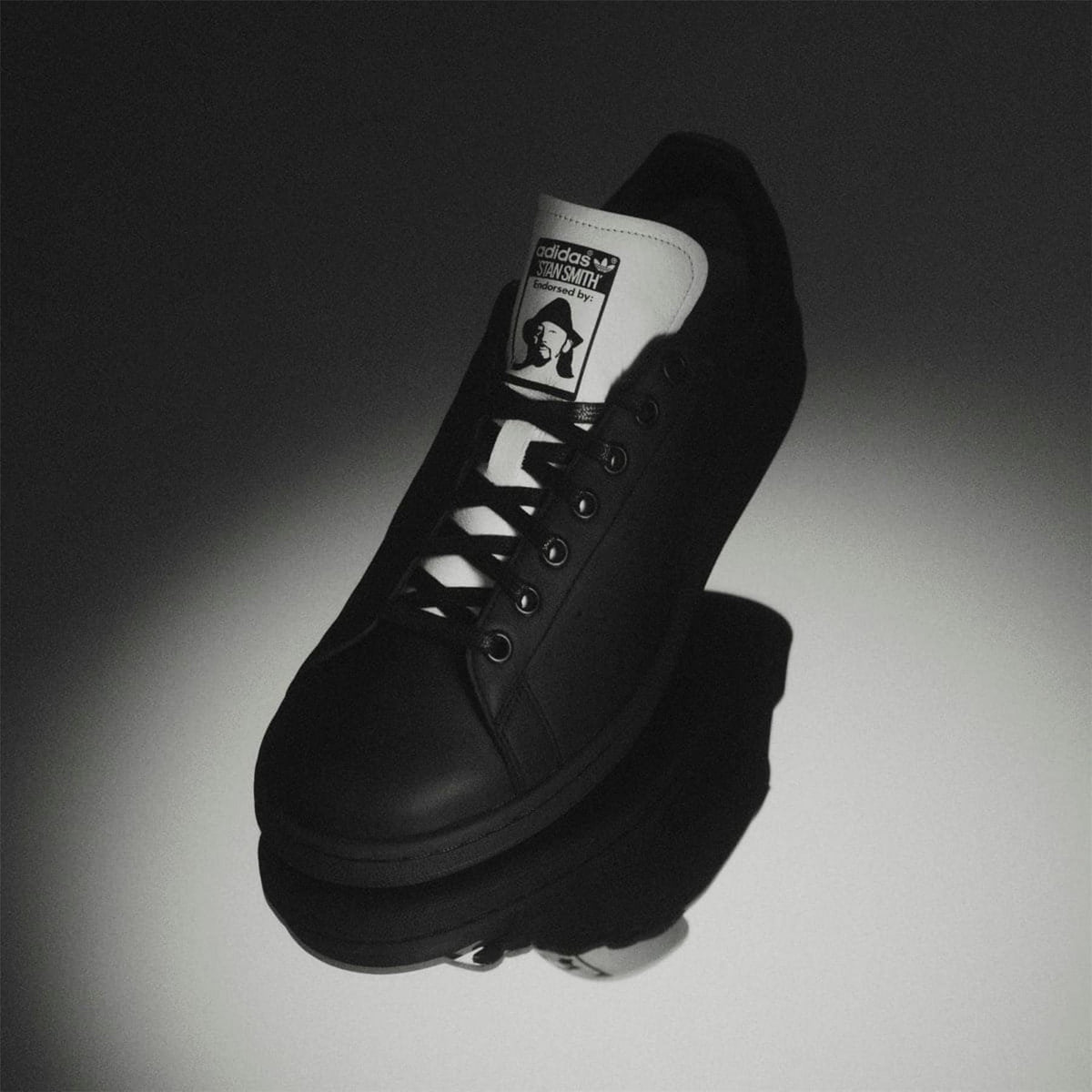 Black leather low-top sneaker with adidas logo tongue label and lace-up closure