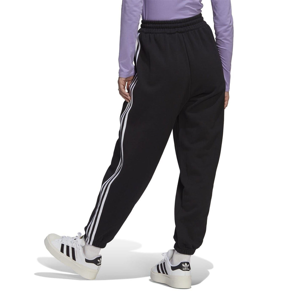 adidas Originals Relaxed Joggers, navy blue track pants with elastic waistband and tapered fit, casual athletic style