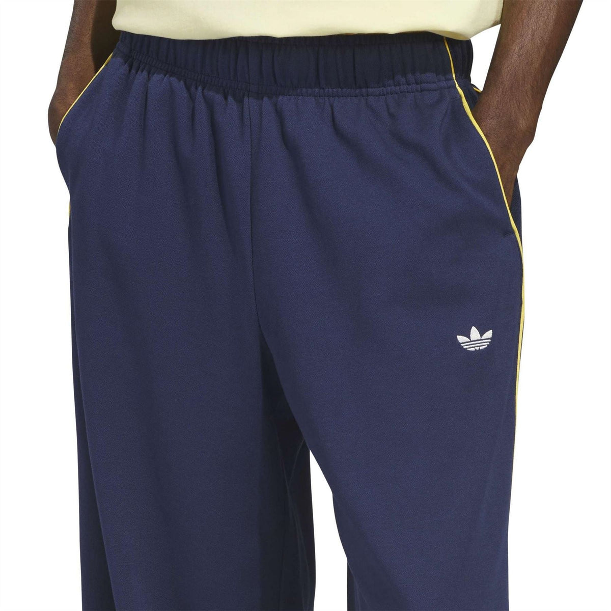 adidas Originals men’s navy joggers with elastic waist, yellow side stripes, trefoil logo