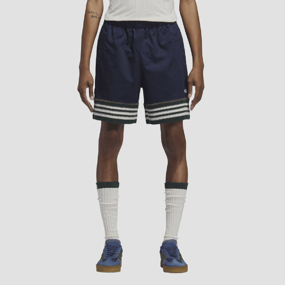 Indigo knit shorts on model, elastic waist and striped band at hem