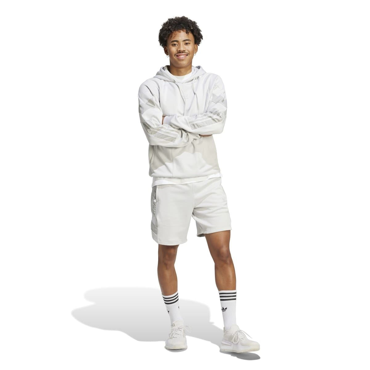 Light grey athletic shorts worn with crew socks and white sneakers
