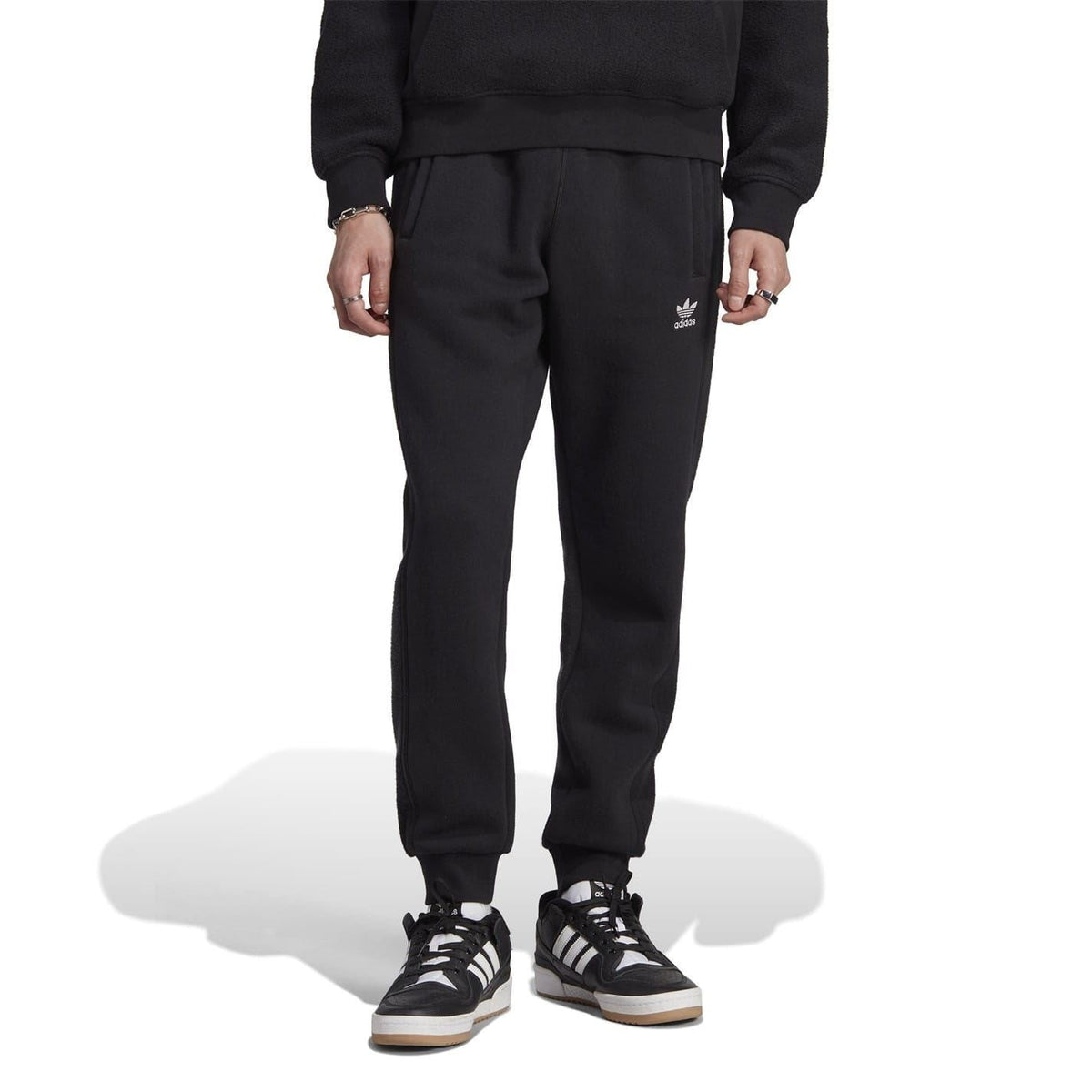 Black tapered joggers with side logo and ribbed ankle cuffs