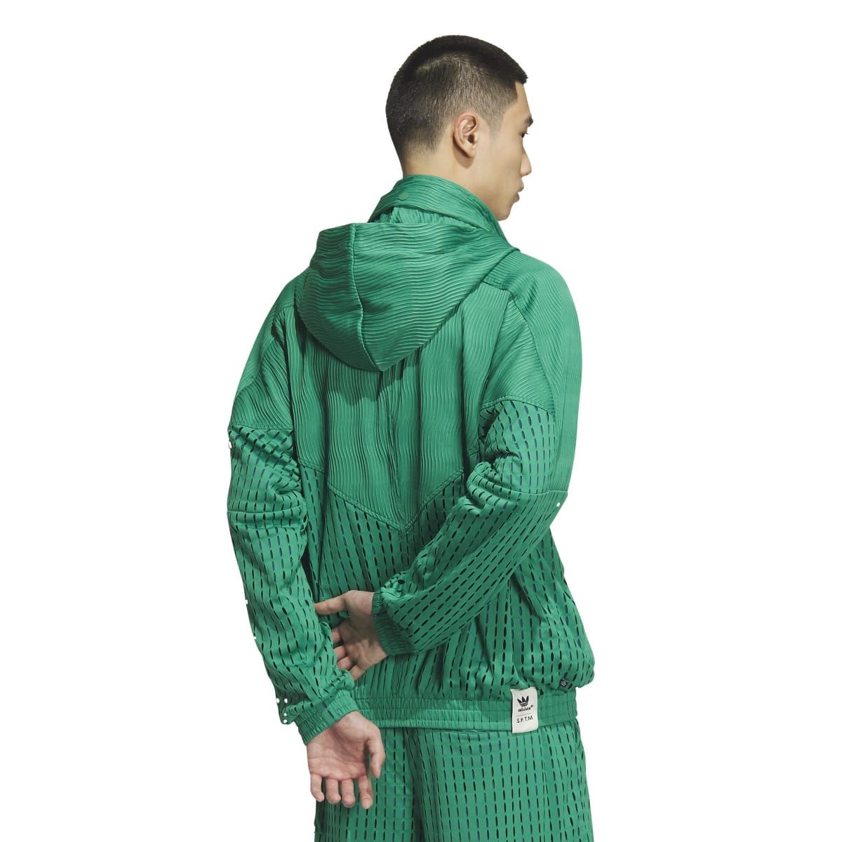 Green hooded zip jacket viewed from the back, ribbed cuffs and textured knit panels