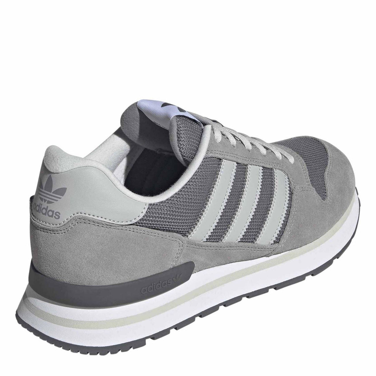 Grey and white lace-up sneaker with cushioned collar and side stripe branding patch