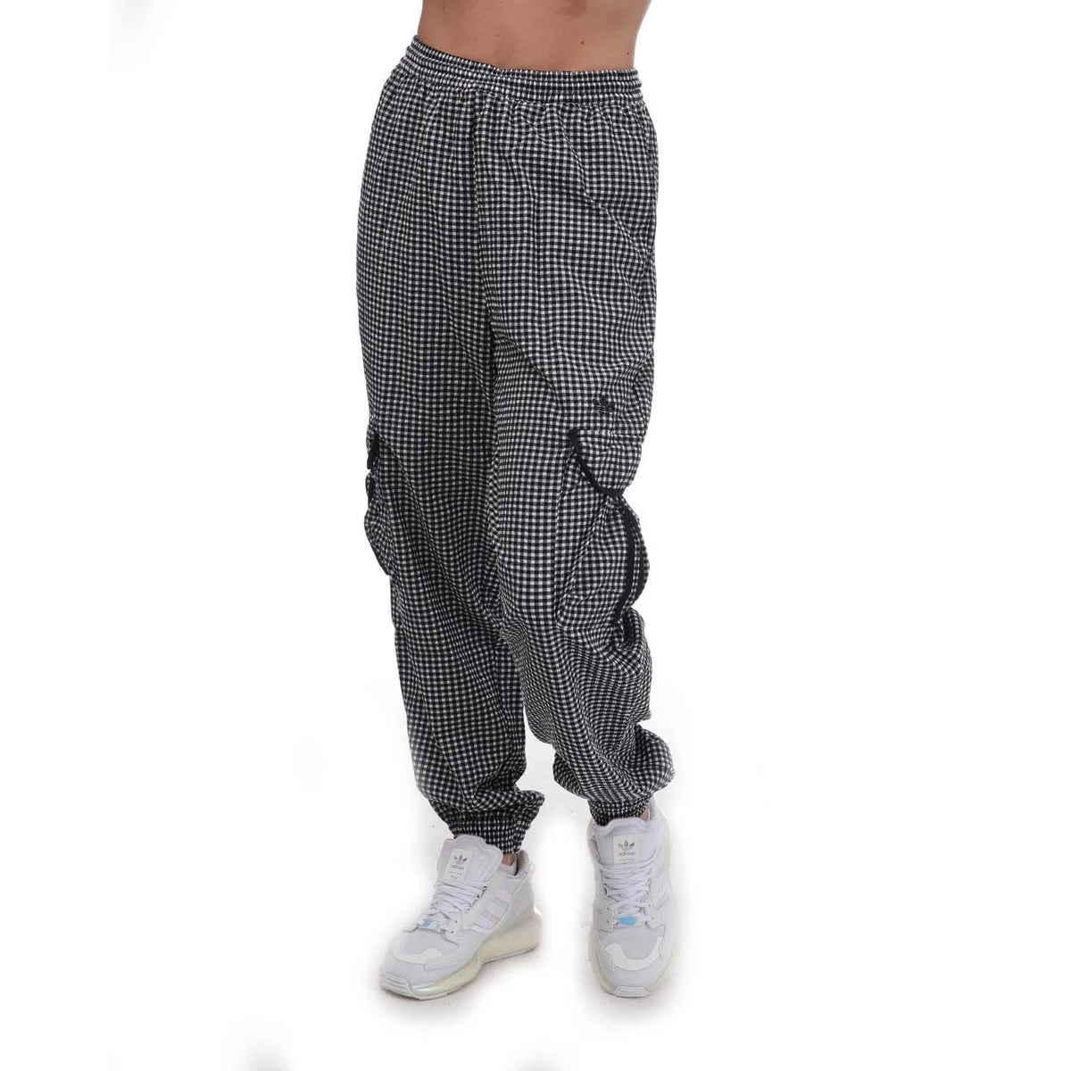 adidas Originals Gingham Track Pants showing black and white checkered pattern and relaxed fit on model
