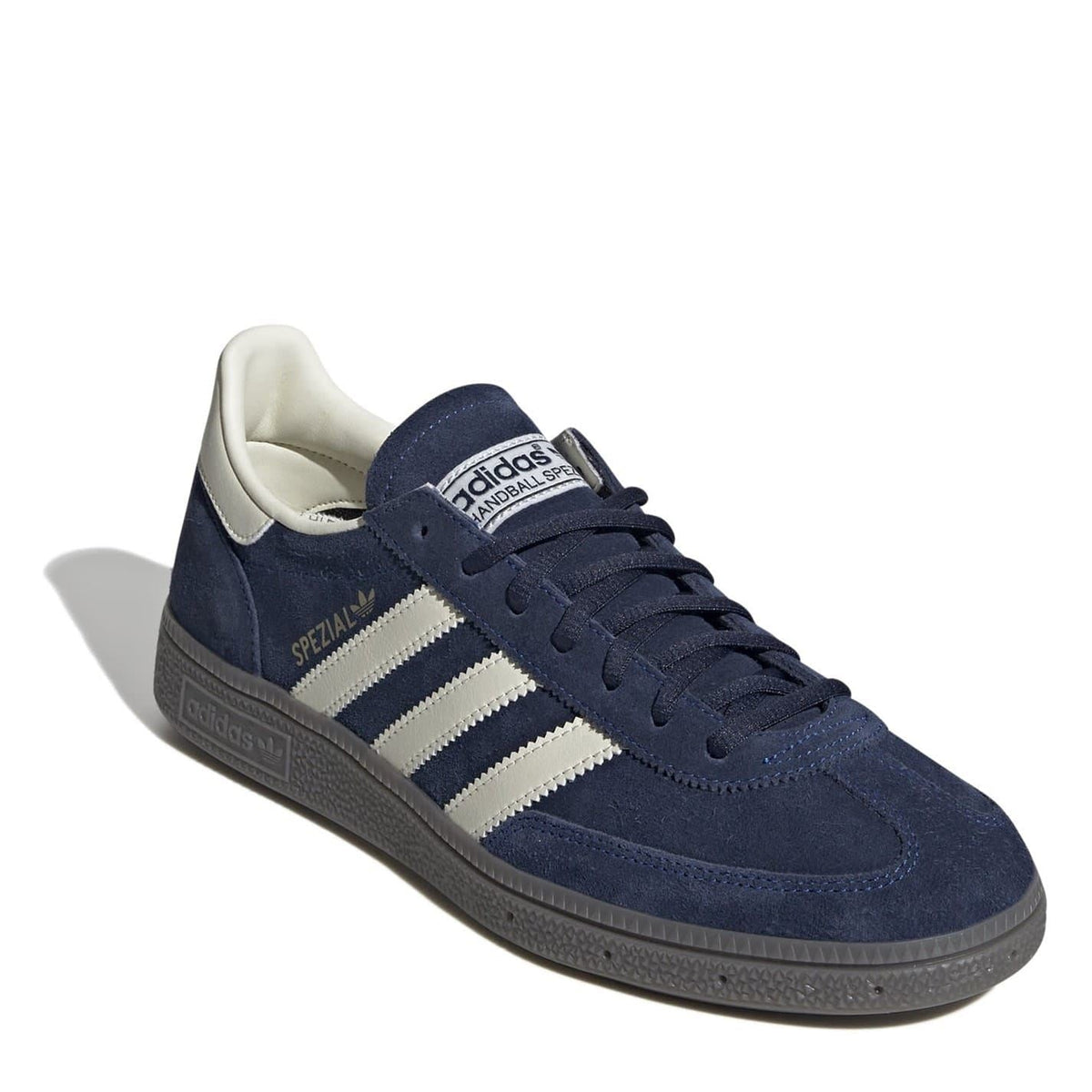Navy suede low top sneakers side view with white stripes and dark lace-up.