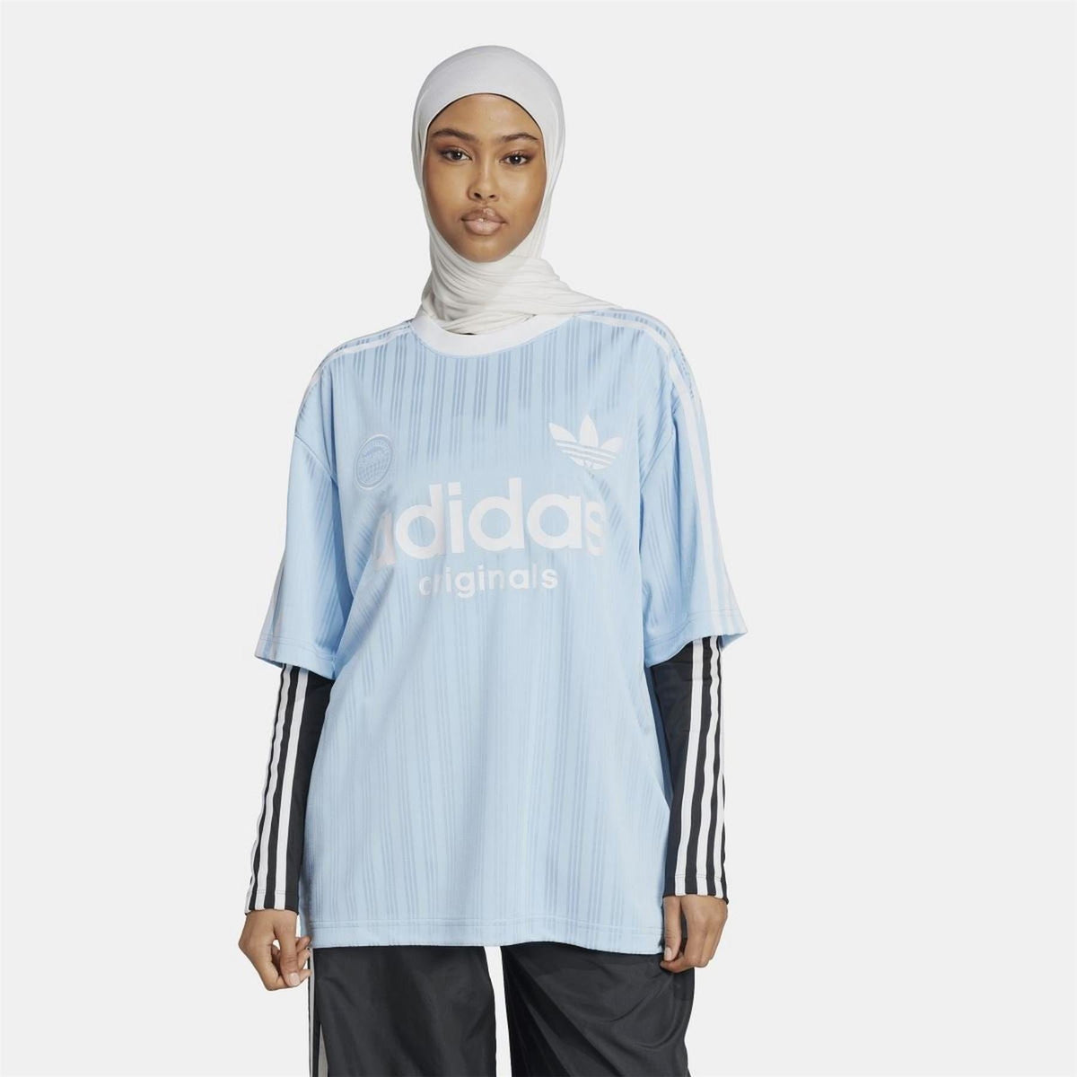 Light blue adidas Originals T-shirt worn with striped sleeves and trefoil front logo