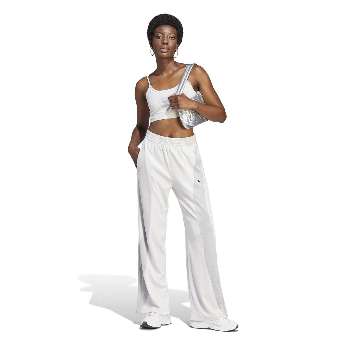 White cropped sports bra with thin straps and small chest logo