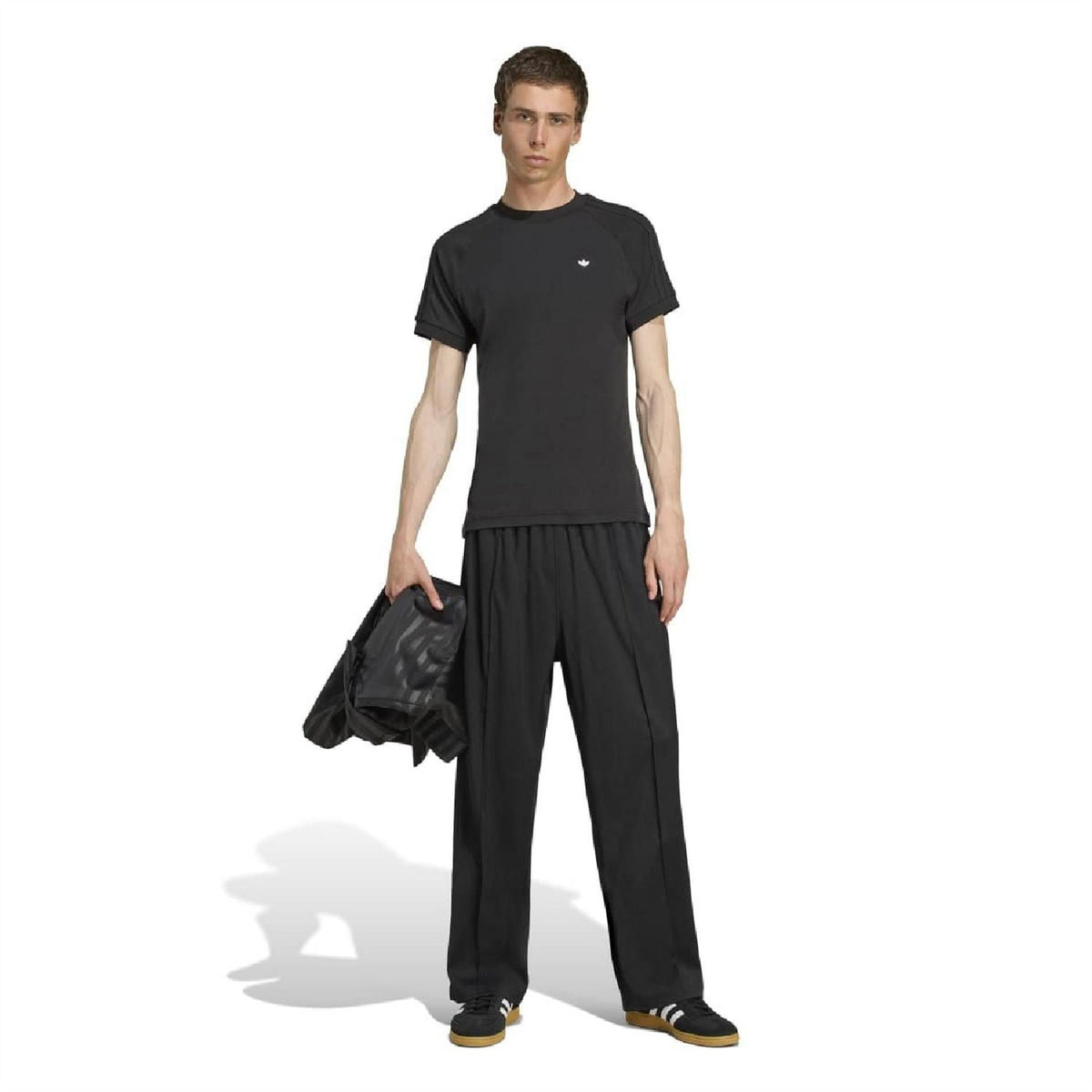 Black crew-neck T-shirt on model, small adidas Originals logo at left chest