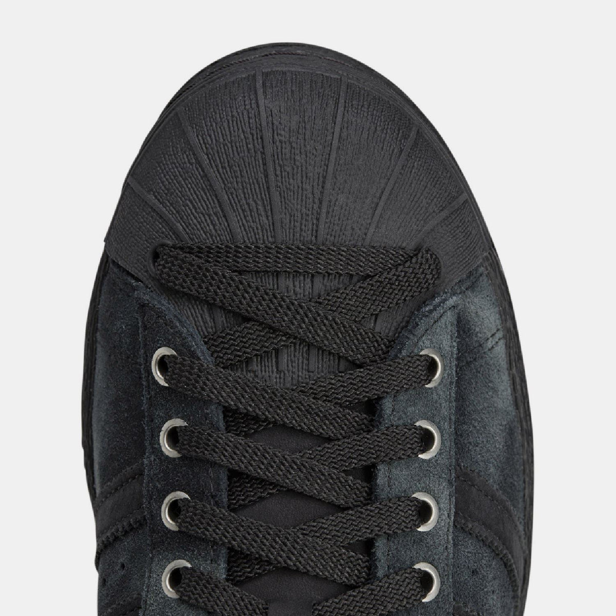 adidas Originals SFTM Superstar 82 trainers, stylish footwear with classic design, white color, and textured sole.
