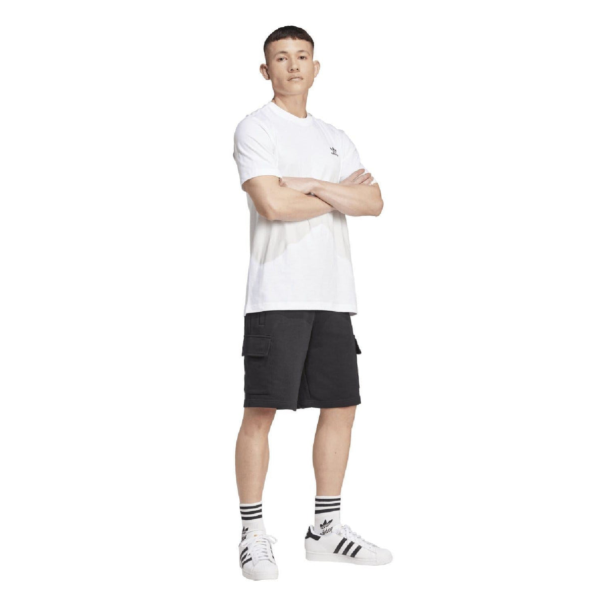White adidas Originals crew-neck T-shirt worn with black shorts, side view